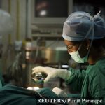 Dr Manoj Kumar J Manwani (L), senior consultant in cosmetic and plastic surgery, and his assistant perform cosmetic surgery inside a hospital operation theater in Mumbai May 9, 2008. For years, Indian women have been relying on the surgeon's knife for that perfect body, that flawless face, and now, the men are muscling in. Body enhancing procedures are no longer only for the female, the self-conscious or the wealthy, with India's economic boom spawning a new breed of male, middle-class professionals with the desire to look good and the money to make it happen. To match Reuters Life! INDIA-MEN/SURGERY REUTERS/Punit Paranjpe (INDIA) - RTX5Z46